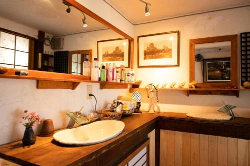a bathroom with a sink and a counter top at 古民家の宿 ふるま家 Furumaya House Gastronomic Farmstay in Deep Kyoto in Fukuchiyama