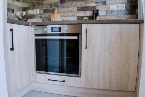 a kitchen with a counter with a microwave in it at Loutraki hidden Gem II in Loutraki