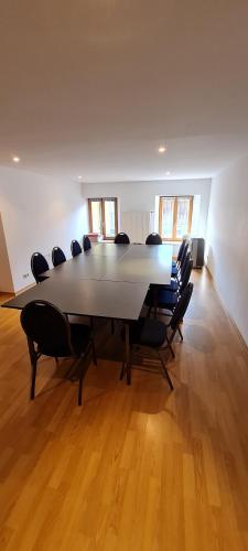 a large meeting room with a large table and chairs at Gasthof - Hotel zur Post in Pöcking