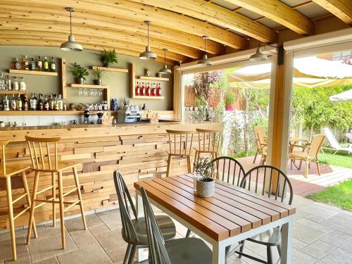 レティムノ・タウンにあるOlympia Hotelの木製バー(テーブル、椅子付)のあるレストランを提供しています。