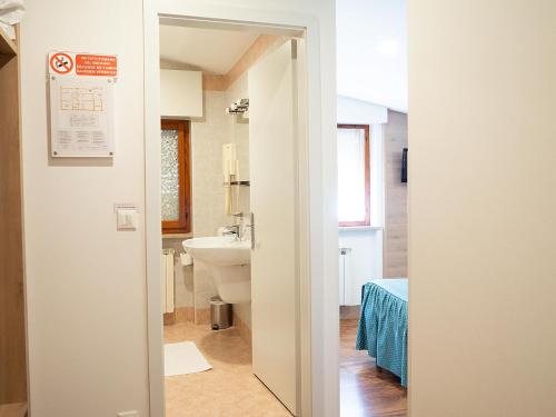 a bathroom with a toilet and a sink at Al Benvenuto Hotel & Restaurant in Tolmezzo
