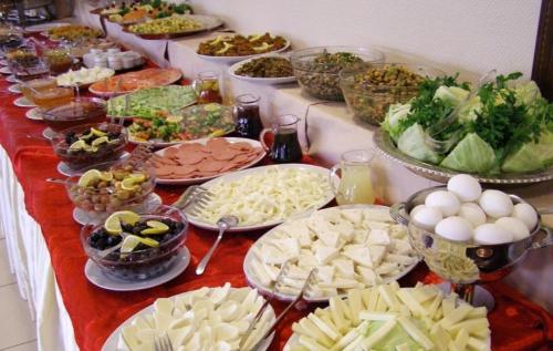 a buffet with many plates of food on a table at Maris Hotel Baku in Baku