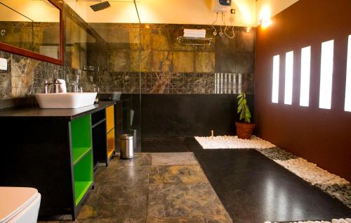 a bathroom with a sink and a counter at Pranavam Resort & Spa in Tariyod