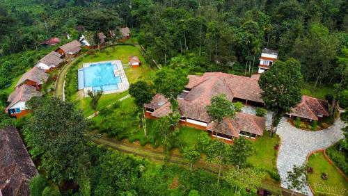 an aerial view of a house with a swimming pool at Pranavam Resort & Spa in Tariyod