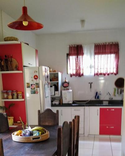 a kitchen with a table with a bowl of fruit at Casa Amarela in Uberlândia