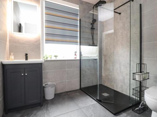 a bathroom with a shower and a toilet and a sink at 6A Elms Road in Morecambe