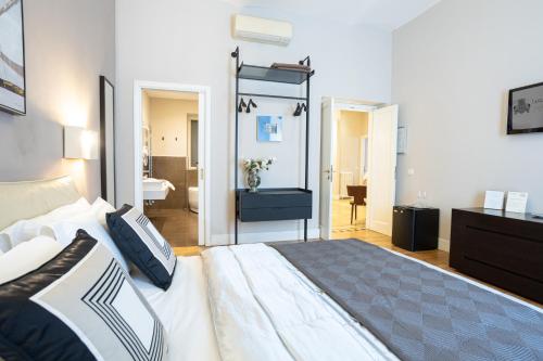 a bedroom with a large bed and a bathroom at Cardilli Luxury Rooms in Rome
