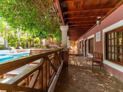 an outside view of a house with a porch and a pool at Palma Real Posada in Puerto Iguazú
