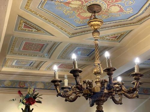 a chandelier hanging from the ceiling in a building at Palazzo Barbini Dimora Storica in Castiglione del Lago