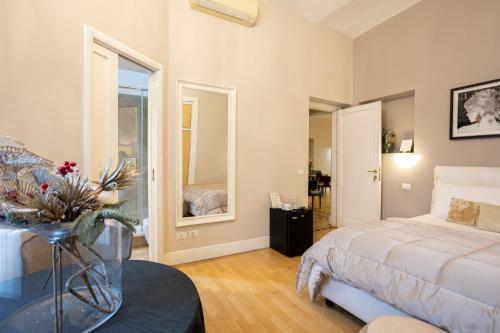 a bedroom with a bed and a table in a room at Cardilli Luxury Rooms in Rome