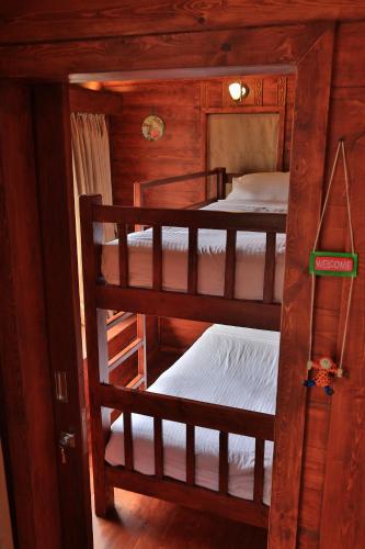 a room with three bunk beds in a cabin at Accord Highland Hotel Ooty in Ooty