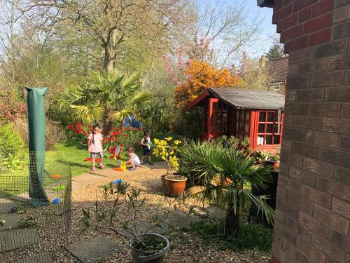 a group of children playing in a garden at Beautiful double en-suite room in Oakham