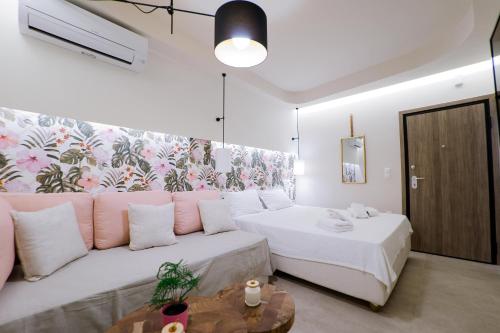 a living room with two beds and a couch at Loutraki Pinky Pearl in Loutraki