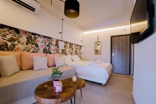 a living room with a bed and a couch at Loutraki Pinky Pearl in Loutraki