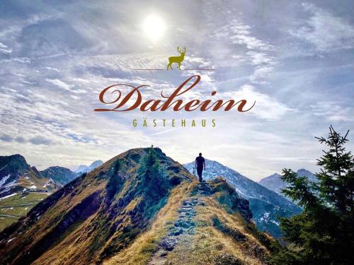 a poster for a movie with a man on top of a mountain at Gästehaus Daheim in Riezlern