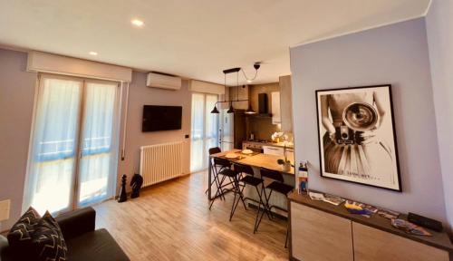 a living room with a kitchen and a dining room at La Tana Del Ludo in Baveno