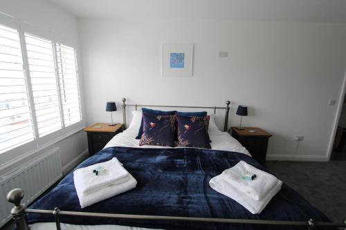 a bedroom with a bed with two towels on it at SEACLIFF ROAD APARTMENT in Bangor