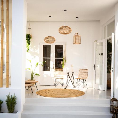 a hallway with chairs and pendant lights at Eleana Hotel in Tinos Town