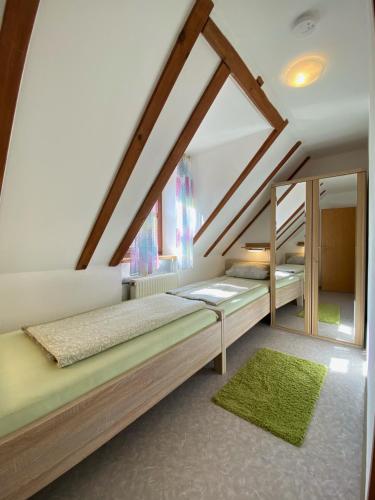 a bedroom with two beds in a attic at Bernerhof in Pottenstein