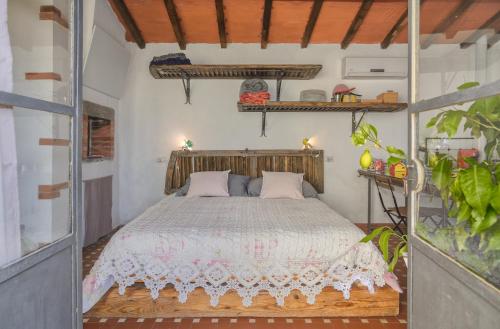 a bedroom with a bed with a wooden headboard at La Limonaia di Casagrande in Barga