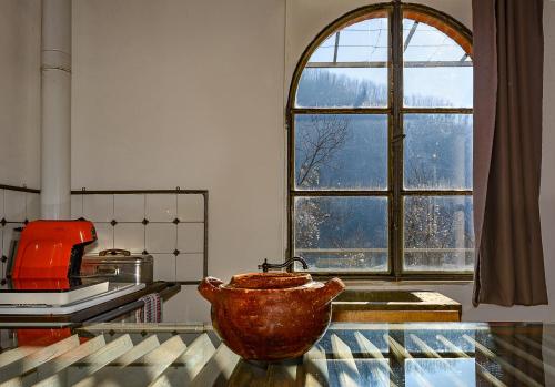 a kitchen with a large bowl on a counter with a window at La Limonaia di Casagrande in Barga
