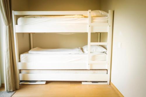 a bedroom with two bunk beds in a room at HuysHoeve in Knokke-Heist