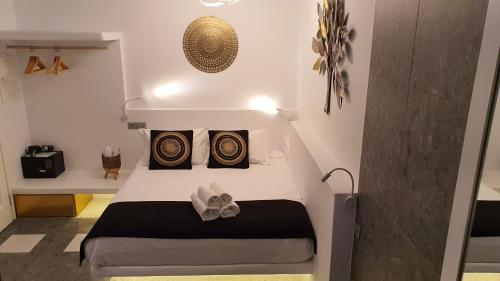 a small bedroom with a bed in a room at Mykonos Double Luxury Mini Suites-With External Hot spa Adults only in Ano Mera