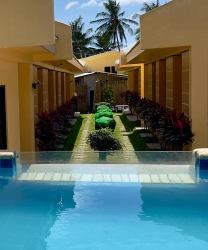 a swimming pool in front of a building at GOLDEN SUNSET INN in Siquijor