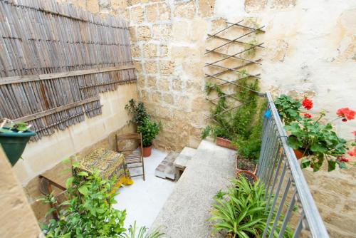 a small courtyard with plants and a stair case at Maria Townhouse Heart of Victoria B&B in Victoria