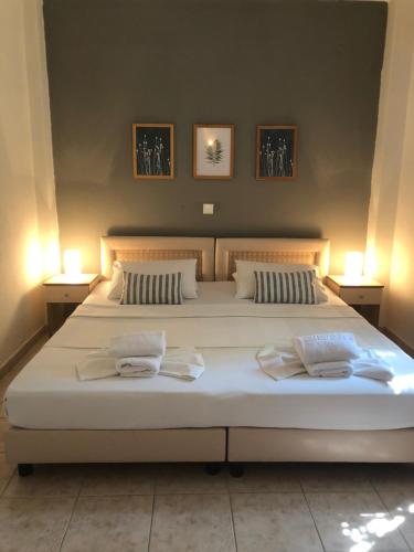 a bedroom with a large bed with two pillows at DERES Apartments in Hanioti