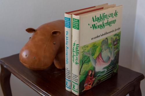 two books sitting on a table next to a stuffed animal at 's Lands Welvaren in Aardenburg