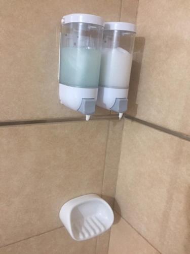 a bathroom stall with a urinal and a toilet at Centro Peru in Paraná