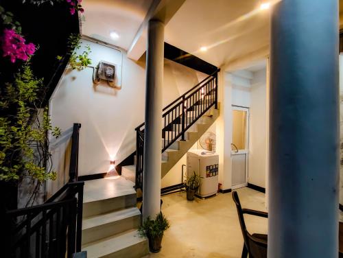 a staircase in a house with a stair case at Flower Shade Villa in Weligama