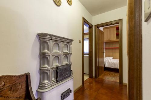 a room with a fireplace and a bedroom with a bed at Val Fassa in Campitello di Fassa