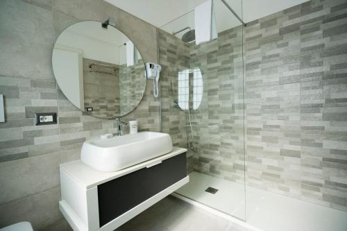 a bathroom with a sink and a mirror at Gemelli Sweet Holiday in Rome
