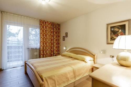 a bedroom with a bed and a window at Val Fassa in Campitello di Fassa