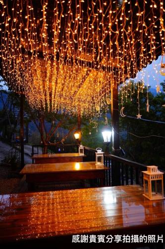 a bunch of lights are hanging from a umbrella at Lala Mountain Homestay‧Cile Farm in Hualing