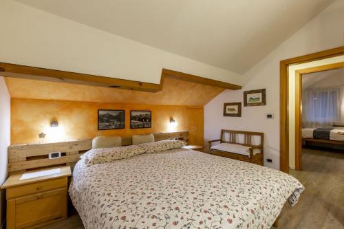 Un dormitorio con una cama grande y un espejo. en Val Fassa, en Campitello di Fassa