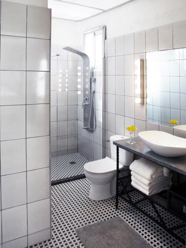 a bathroom with a toilet and a sink and a shower at RoofTop Boutique Hotel Adults Only in Serekunda