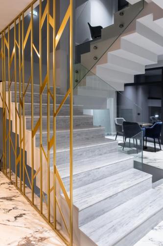 a staircase with yellow railings in a building at Vila Avy in Haţeg