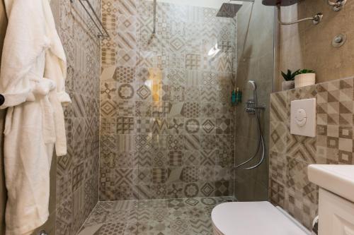 a bathroom with a shower with a toilet and a sink at Angie Central Rooms in Zadar
