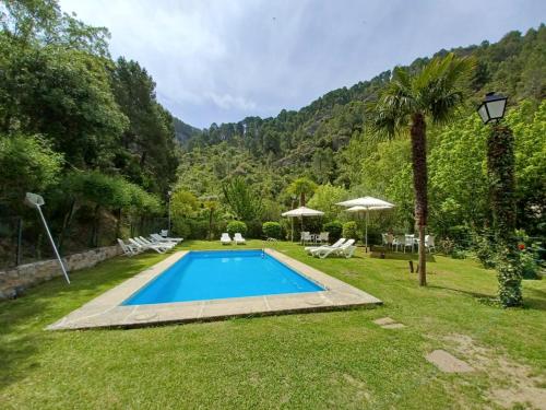 a swimming pool in the middle of a yard at Casa Fuente de Rechita in La Iruela