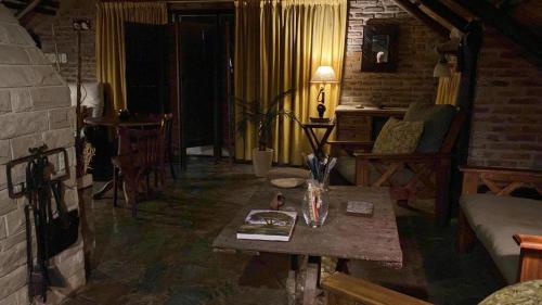 a living room with a table and a couch at Ruda Lodge Exclusive Bed & Breakfast in General Rodríguez