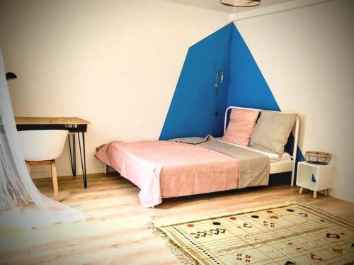 a bedroom with a bed with a blue tent at Une maison design dans le centre ville in Foix