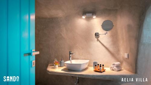 a bathroom with a bowl sink on a counter at Traditional Cave Villas with Jacuzzi, Terrace and Sea view - Sando in Vourvoulos