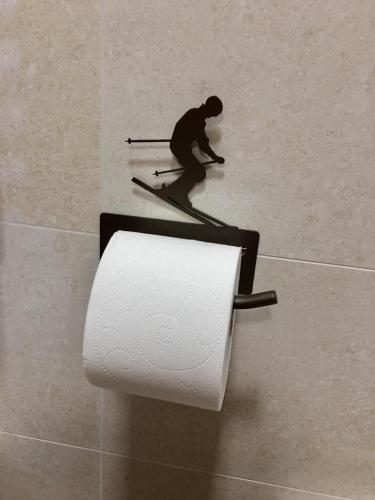 a paper towel dispenser with a man on a roll of toilet paper at EMARGHE, CASA A MOENA in Moena