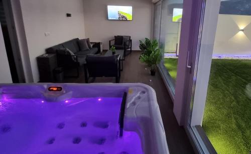 a room with a bath tub with a living room at Istočno Sarajevo in Sarajevo