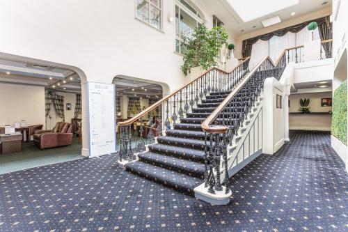 a set of stairs in a building with a lobby at The Worcester Whitehouse Hotel in Worcester