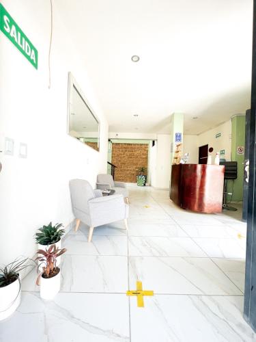 an office lobby with a cross on the floor at Hotel Hai Do in Bernal