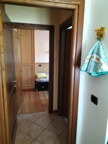 a hallway with a door and a room with a bed at Baita Rutic in Oga
